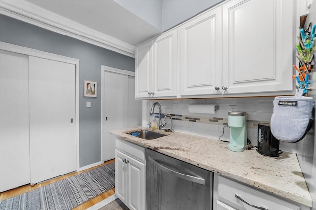 120 E Hartsdale Unit 3L, Hartsdale, NY 10530 - kitchen with stainless steel dishwasher, a sink, backsplash, white cabinetry, and light stone counters