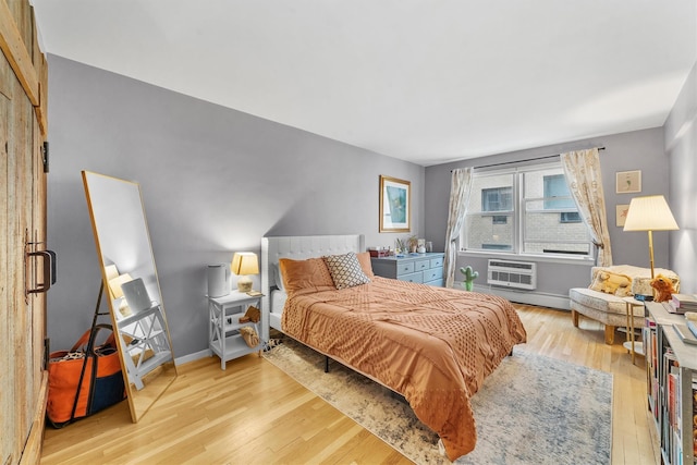 120 E Hartsdale Unit 3L, Hartsdale, NY 10530 - bedroom featuring wood finished floors, a wall mounted air conditioner, and baseboards