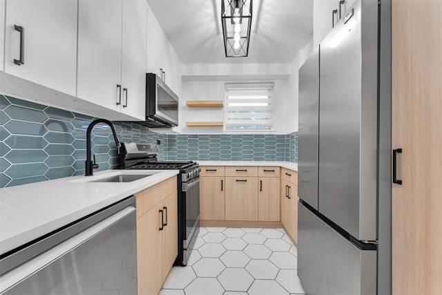 5700 Arlington Ave Unit 5D, Bronx, NY 10471 - kitchen with appliances with stainless steel finishes, light brown cabinets, a sink, light countertops, and backsplash