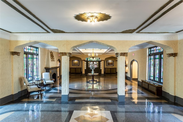 common area featuring a textured wall and crown molding