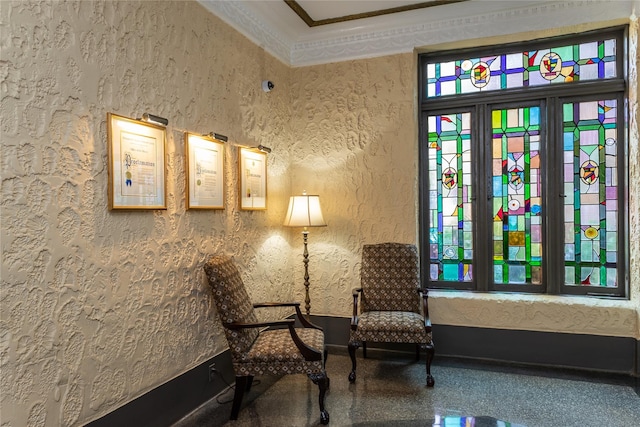 living area featuring ornamental molding and baseboards