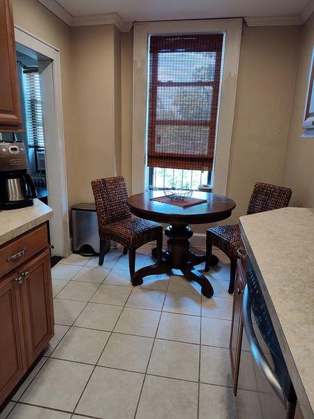 dining space with ornamental molding and light tile patterned floors