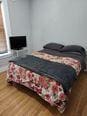 bedroom with a fireplace and wood finished floors