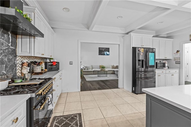 2 Fieldstone Ct, Highland, NY 12528 - kitchen with stainless steel fridge with ice dispenser, gas stove, beamed ceiling, wall chimney range hood, and backsplash