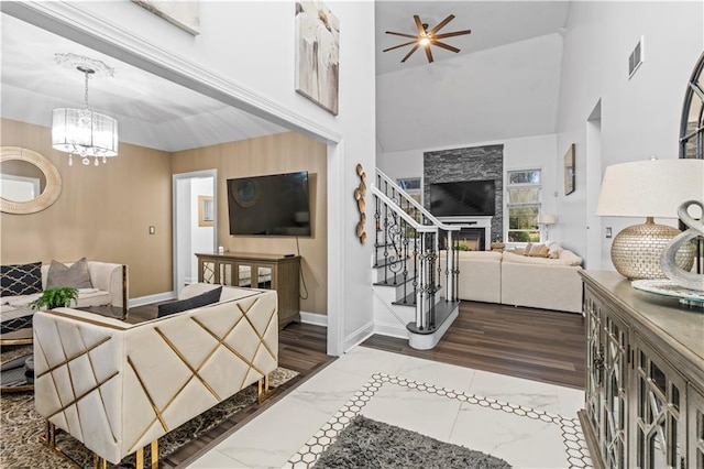 2 Fieldstone Ct, Highland, NY 12528 - living area featuring stairs, a chandelier, a high ceiling, baseboards, and a fireplace