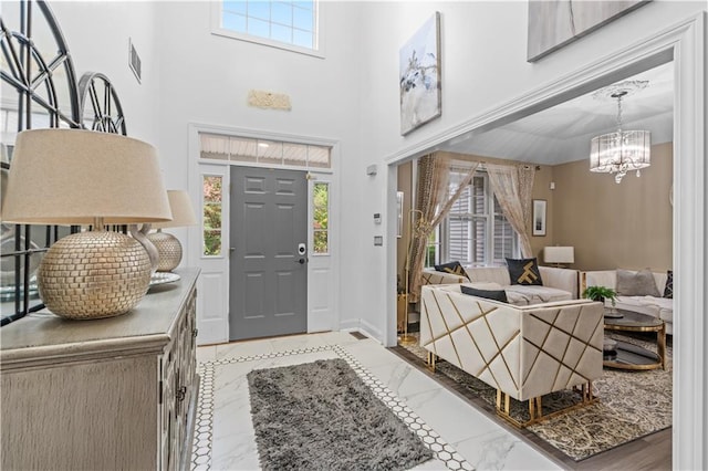 2 Fieldstone Ct, Highland, NY 12528 - entrance foyer featuring plenty of natural light, a chandelier, baseboards, and marble finish floors