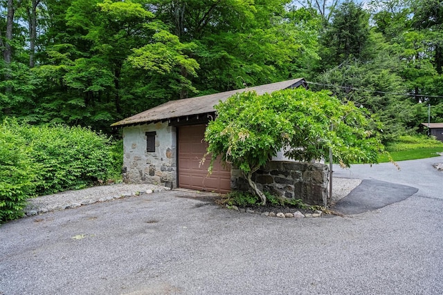 1670 Baptist Church Rd, Yorktown Heights, NY 10598 - view of outbuilding with a view of trees, asphalt driveway, and a garage
