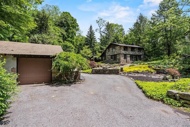 1670 Baptist Church Rd, Yorktown Heights, NY 10598 - view of front of property with stone siding, a garage, and driveway