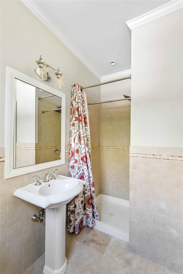 39A Foster Rd, Quogue, NY 11959 - bathroom featuring ornamental molding, a tile shower, tile patterned flooring, and tile walls