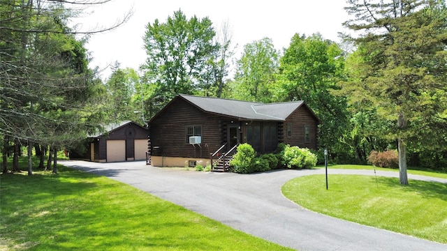 29 Fallen Tree Ln, Athens, NY 12051 - view of front facade featuring log exterior, an outdoor structure, a detached garage, and a front lawn