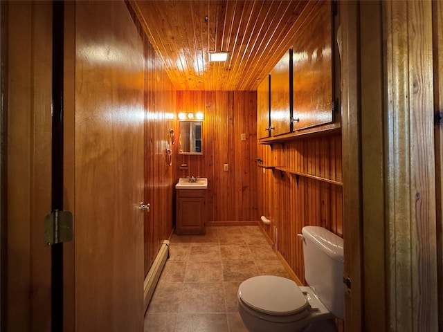 29 Fallen Tree Ln, Athens, NY 12051 - bathroom featuring wood ceiling, toilet, vanity, tile patterned flooring, and wooden walls