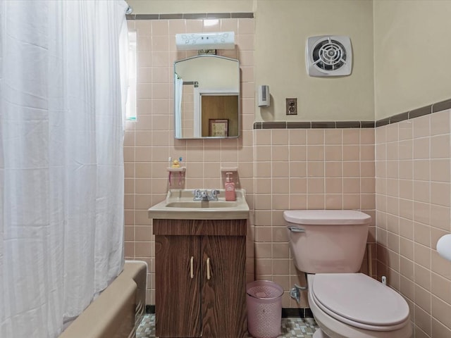 1311 154th St, Beechhurst, NY 11357 - bathroom featuring tile walls, vanity, toilet, and shower / bath combo