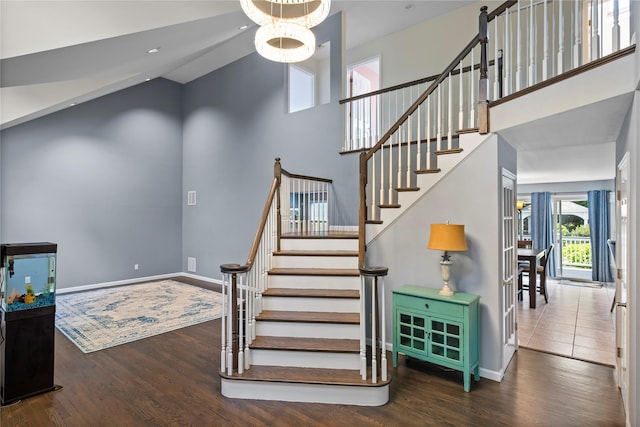 2 Old Brookville Ct, Manorville, NY 11949 - stairway with wood finished floors, a towering ceiling, and a chandelier