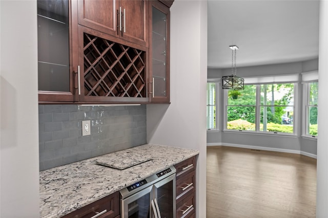 2 Old Brookville Ct, Manorville, NY 11949 - kitchen with backsplash, glass insert cabinets, light stone counters, and beverage cooler