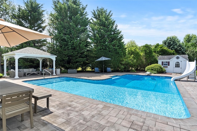 2 Old Brookville Ct, Manorville, NY 11949 - view of swimming pool with outdoor lounge area, a gazebo, a water slide, and a patio area