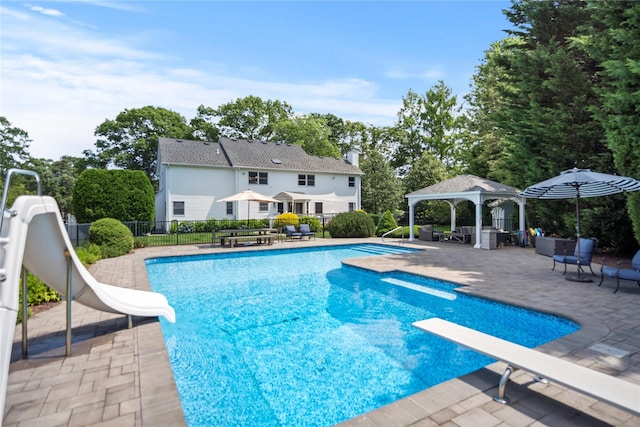 2 Old Brookville Ct, Manorville, NY 11949 - view of pool featuring a water slide, a gazebo, a diving board, and a patio