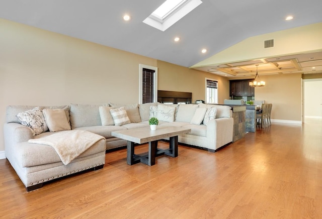 135 Ocean Ave, Massapequa, NY 11758 - living room featuring recessed lighting, light wood-type flooring, a skylight, a chandelier, and baseboards