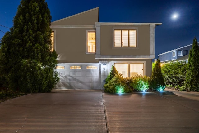 135 Ocean Ave, Massapequa, NY 11758 - contemporary house featuring stucco siding, driveway, and a garage