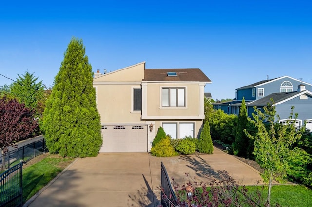 135 Ocean Ave, Massapequa, NY 11758 - view of front of property featuring a garage, concrete driveway, and stucco siding