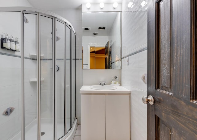 135 Ocean Ave, Massapequa, NY 11758 - bathroom with vanity, a stall shower, and tile walls