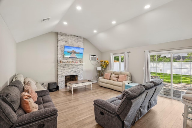 70 Propose Rd, Shirley, NY 11967 - living room featuring vaulted ceiling, a stone fireplace, light wood-style floors, a wall unit AC, and recessed lighting