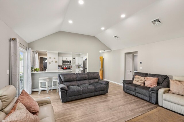 70 Propose Rd, Shirley, NY 11967 - living area featuring vaulted ceiling, light wood-style floors, recessed lighting, and a baseboard heating unit