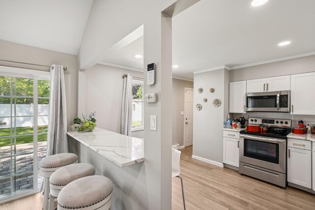 70 Propose Rd, Shirley, NY 11967 - kitchen with stainless steel appliances, light stone counters, decorative backsplash, plenty of natural light, and recessed lighting