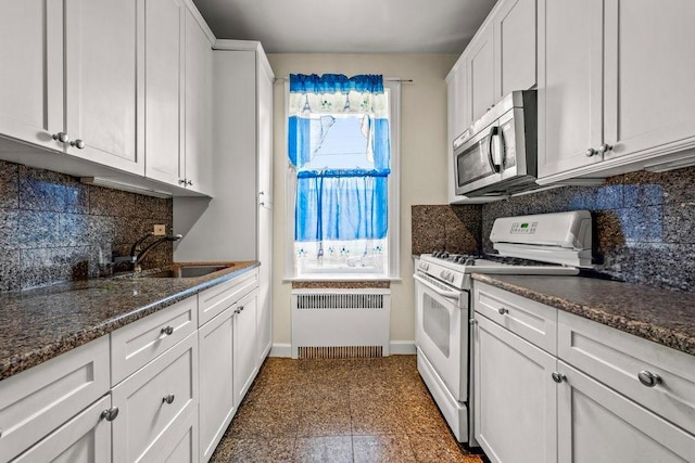 1681 Brooklyn Ave, Brooklyn, NY 11210 - kitchen featuring white gas stove, radiator, stainless steel microwave, a sink, and white cabinetry