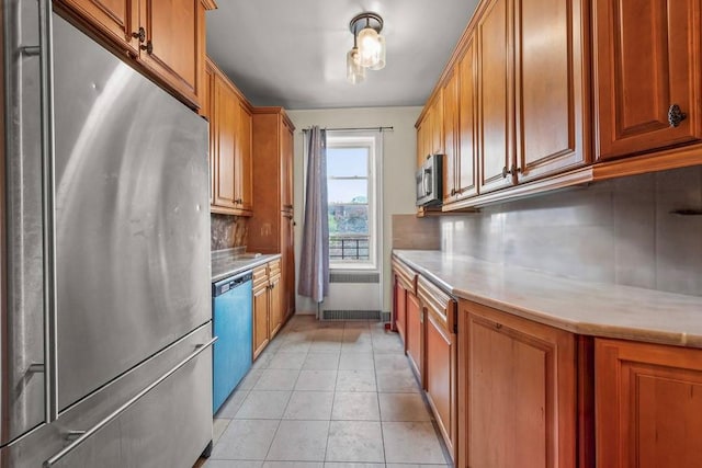 1681 Brooklyn Ave, Brooklyn, NY 11210 - kitchen with appliances with stainless steel finishes, radiator, backsplash, and light countertops