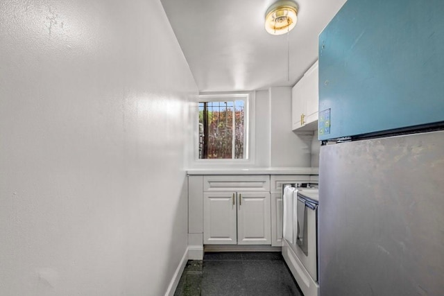 1681 Brooklyn Ave, Brooklyn, NY 11210 - kitchen with freestanding refrigerator, stove, white cabinetry, and light countertops