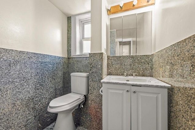 1681 Brooklyn Ave, Brooklyn, NY 11210 - bathroom with tile walls, toilet, vanity, and a wainscoted wall