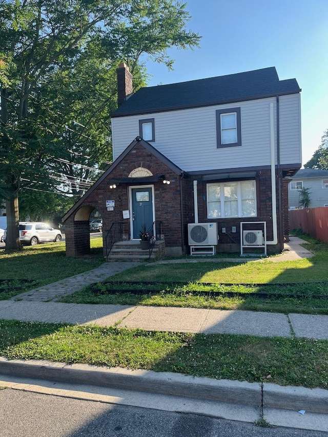 21 James Ll Burrell Ave, Hempstead, NY 11550 - view of front of home with ac unit, a chimney, and brick siding
