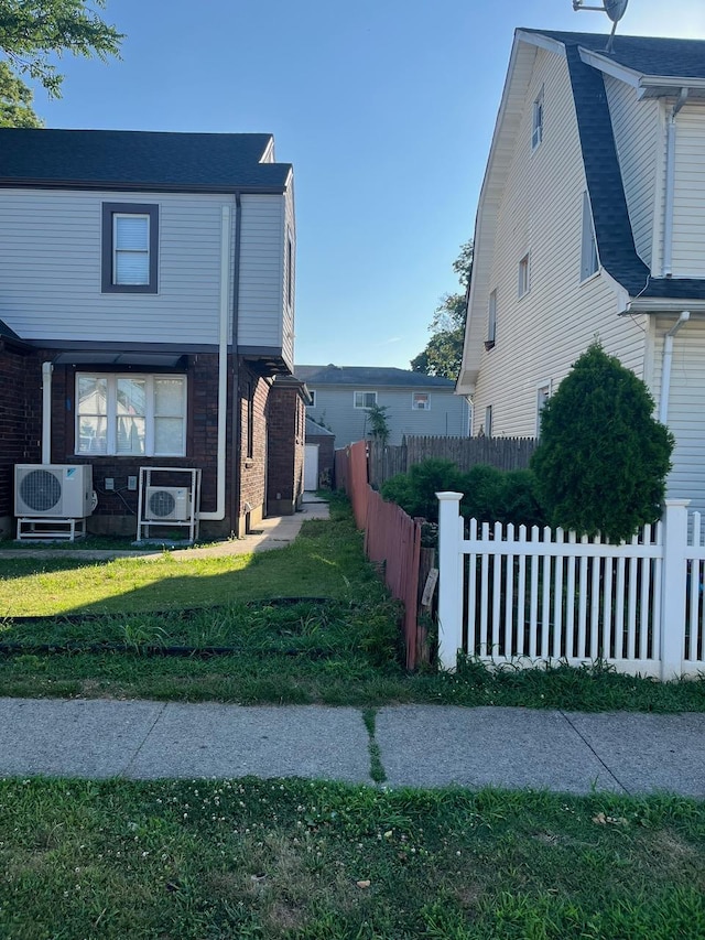 21 James Ll Burrell Ave, Hempstead, NY 11550 - view of home's exterior with brick siding and ac unit
