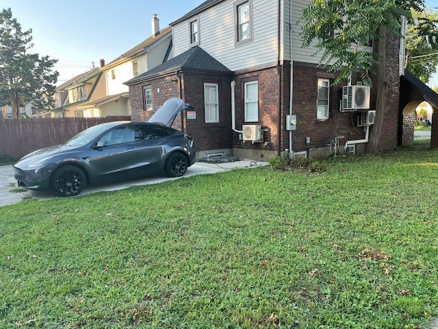21 James Ll Burrell Ave, Hempstead, NY 11550 - view of side of home featuring brick siding and ac unit