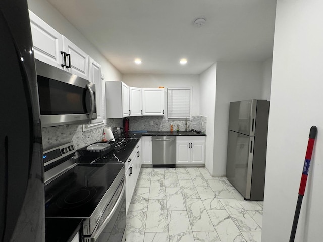 21 James Ll Burrell Ave, Hempstead, NY 11550 - kitchen with appliances with stainless steel finishes, light marble finish flooring, white cabinetry, a sink, and recessed lighting