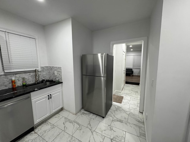 21 James Ll Burrell Ave, Hempstead, NY 11550 - kitchen with stainless steel appliances, light marble finish flooring, a sink, white cabinets, and tasteful backsplash