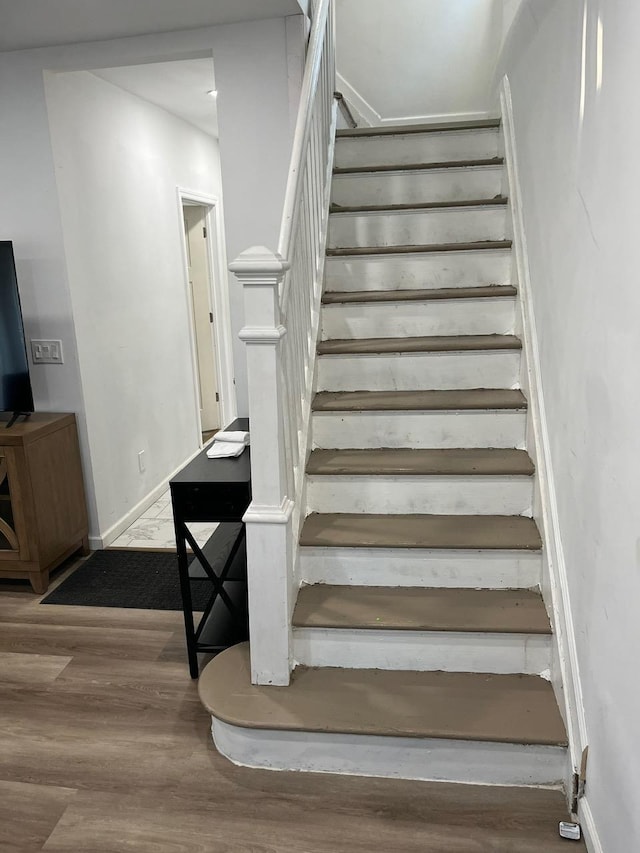 21 James Ll Burrell Ave, Hempstead, NY 11550 - stairs featuring wood finished floors and baseboards