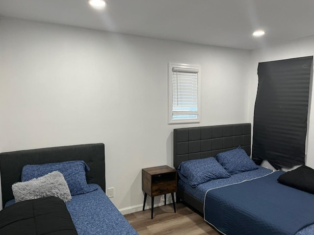 21 James Ll Burrell Ave, Hempstead, NY 11550 - bedroom with wood finished floors, recessed lighting, and baseboards