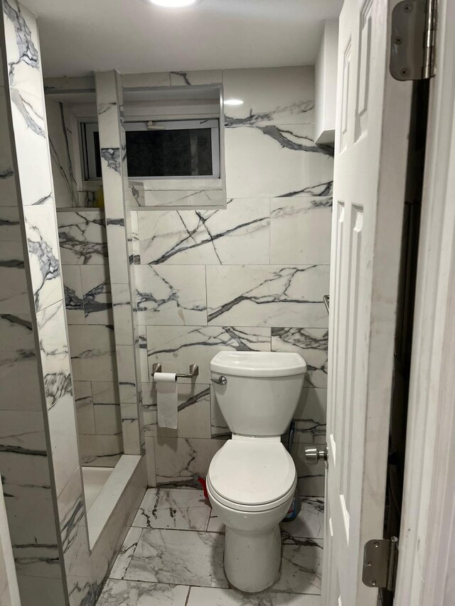 21 James Ll Burrell Ave, Hempstead, NY 11550 - bathroom featuring toilet, marble finish floors, and tile walls
