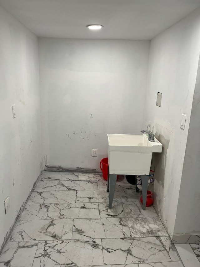 21 James Ll Burrell Ave, Hempstead, NY 11550 - washroom with a sink and light marble finish flooring