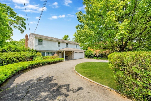 1223 Weaver St, New Rochelle, NY 10804 - view of front of home featuring driveway, stone siding, and a chimney