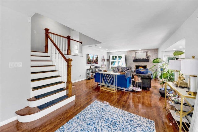 1223 Weaver St, New Rochelle, NY 10804 - living room featuring wood finished floors, baseboards, stairs, and a fireplace