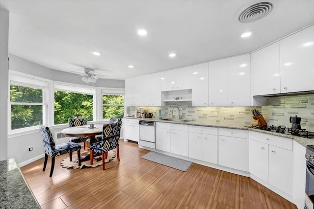 1223 Weaver St, New Rochelle, NY 10804 - kitchen featuring white dishwasher, a sink, black gas cooktop, tasteful backsplash, and recessed lighting