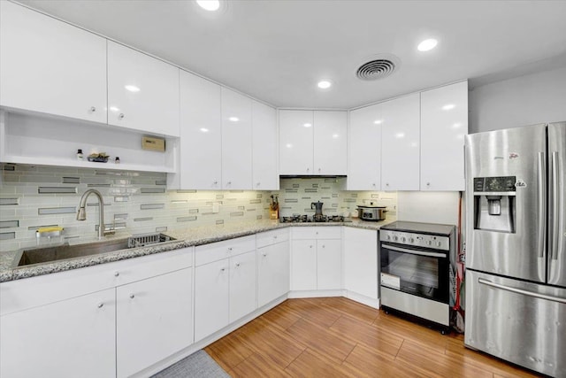 1223 Weaver St, New Rochelle, NY 10804 - kitchen featuring stainless steel fridge with ice dispenser, a sink, oven, white cabinets, and backsplash