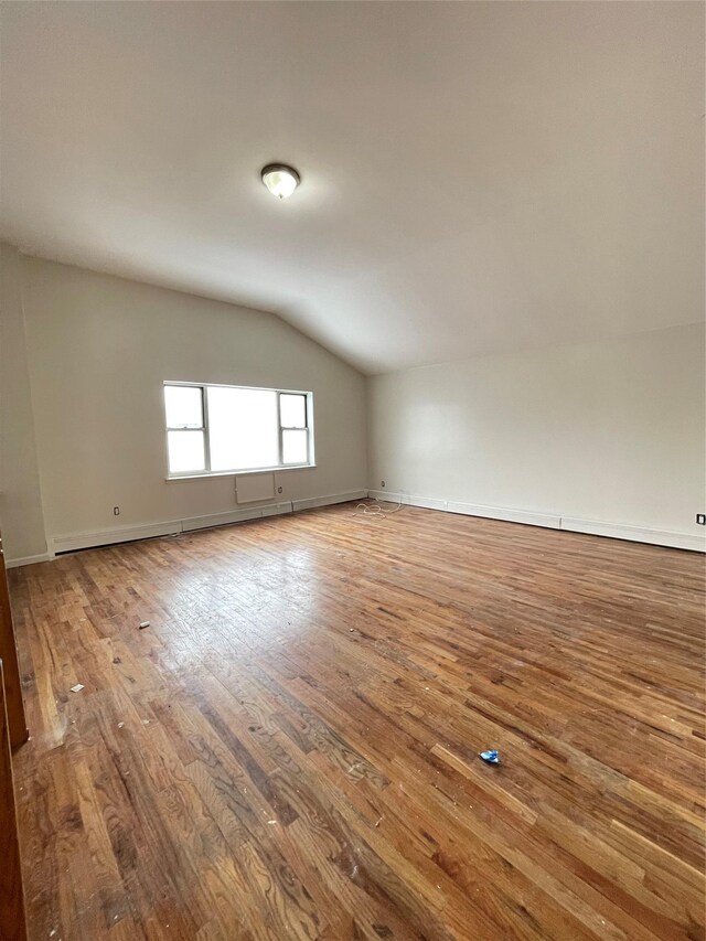 2110 Light St, Bronx, NY 10466 - empty room featuring vaulted ceiling, wood-type flooring, and baseboards