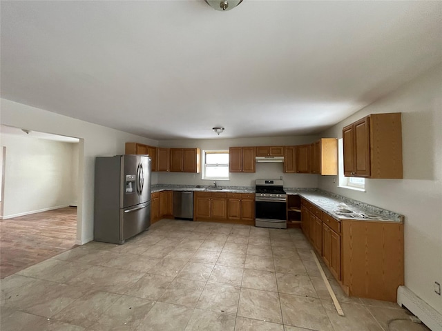 2110 Light St, Bronx, NY 10466 - kitchen featuring stainless steel appliances, under cabinet range hood, a sink, light countertops, and brown cabinets