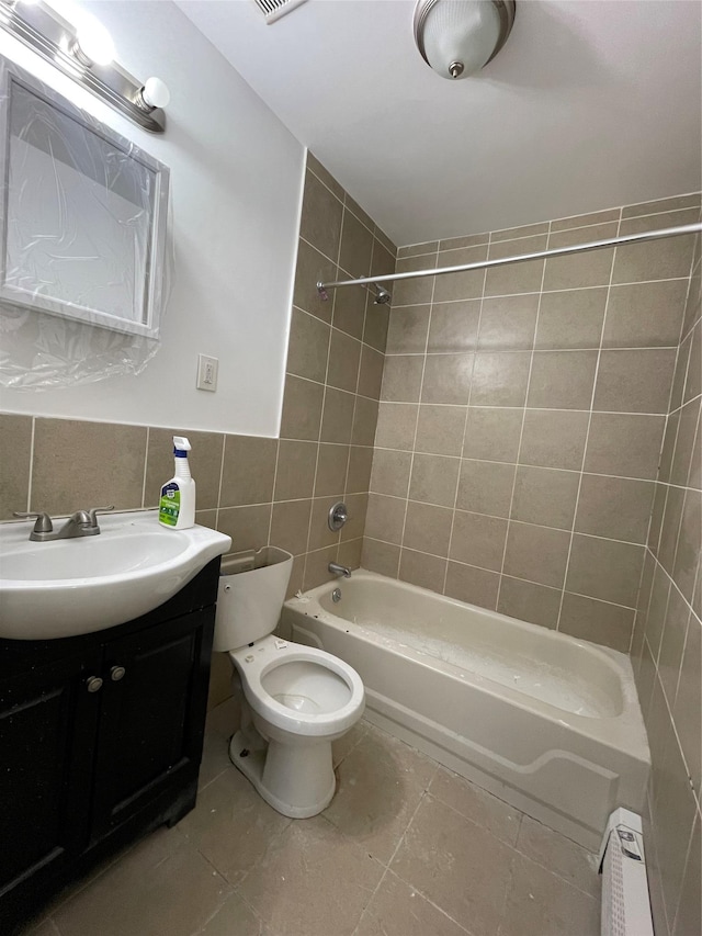 2110 Light St, Bronx, NY 10466 - bathroom featuring tile walls, bathtub / shower combination, toilet, vanity, and tile patterned flooring