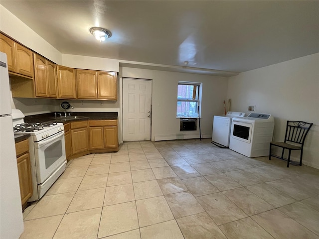 2110 Light St, Bronx, NY 10466 - kitchen featuring white gas range oven, washing machine and dryer, light tile patterned floors, dark countertops, and a baseboard radiator