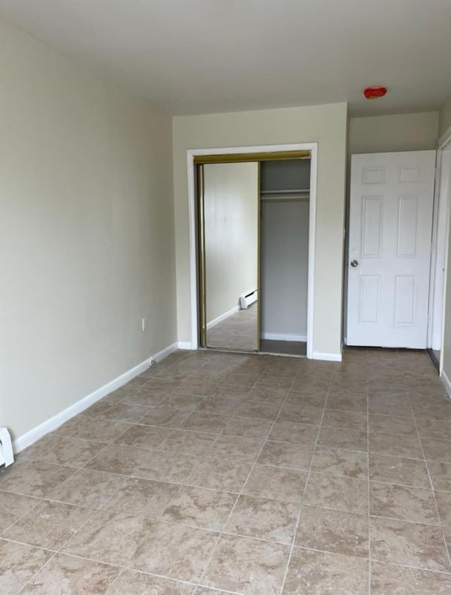 2110 Light St, Bronx, NY 10466 - unfurnished bedroom featuring a closet, baseboards, a baseboard radiator, and light tile patterned floors