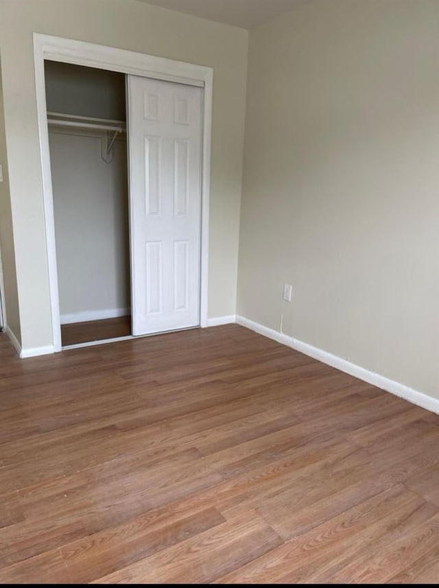 2110 Light St, Bronx, NY 10466 - unfurnished bedroom with a closet, baseboards, and wood finished floors